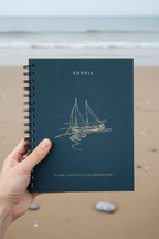 Blue A5 spiral notebook with SOPHIE name and sailboat illustration on cover.