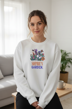 Personalized garden crewneck sweatshirt in white with floral graphic and “SOPHIE’S GARDEN” text.