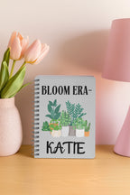 Cream A5 notebook with spiral binding, plant pots illustration and name KATTE