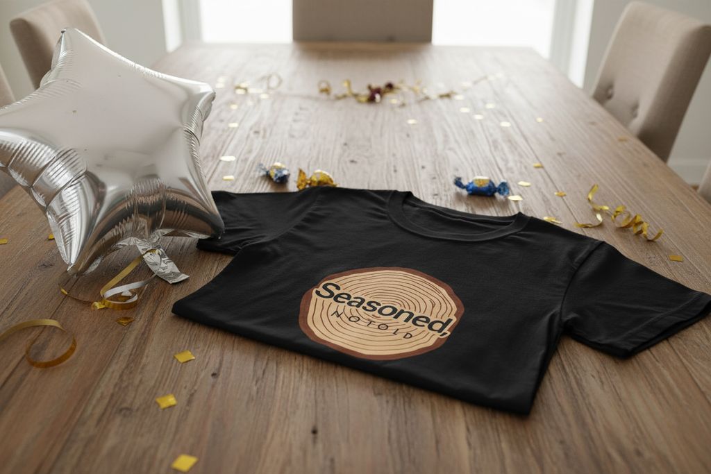 Black crewneck T-shirt with tree-ring “Seasoned, Not Old” graphic