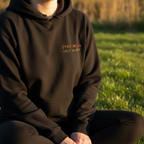 Black pullover hoodie with small chest text "STAY WILD SOFT HEART".