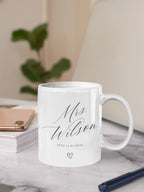 White ceramic mug with 'Mrs Wilson' script, 'ESTD 11.02.2030' and heart icon