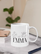 White ceramic mug with floral line art and name EMMA on front