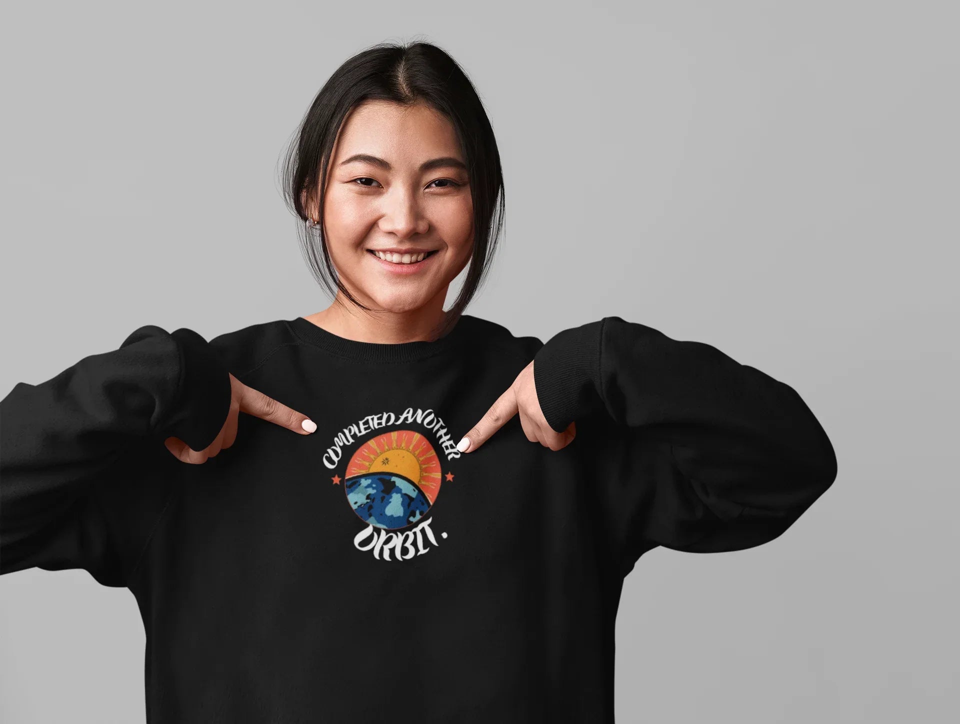 Black crewneck sweatshirt featuring a circular space-themed graphic on the chest