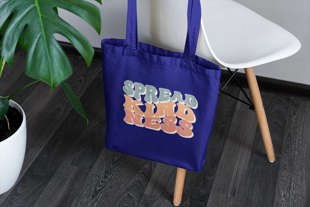 Royal blue cotton tote bag with 'SPREAD KINDNESS' graphic on the front