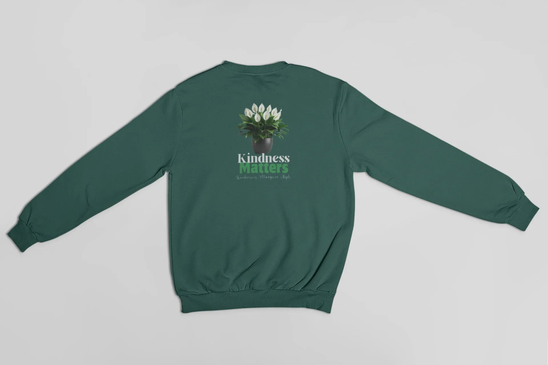 Green crewneck sweatshirt, back view, with tree graphic and 'Kindness Matters' text