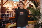 Black crewneck sweatshirt with front graphic print
