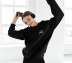 Black unisex sweatshirt with small embroidered headphone logo on chest