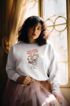 White crewneck sweatshirt with floral inspirational text graphic on the chest