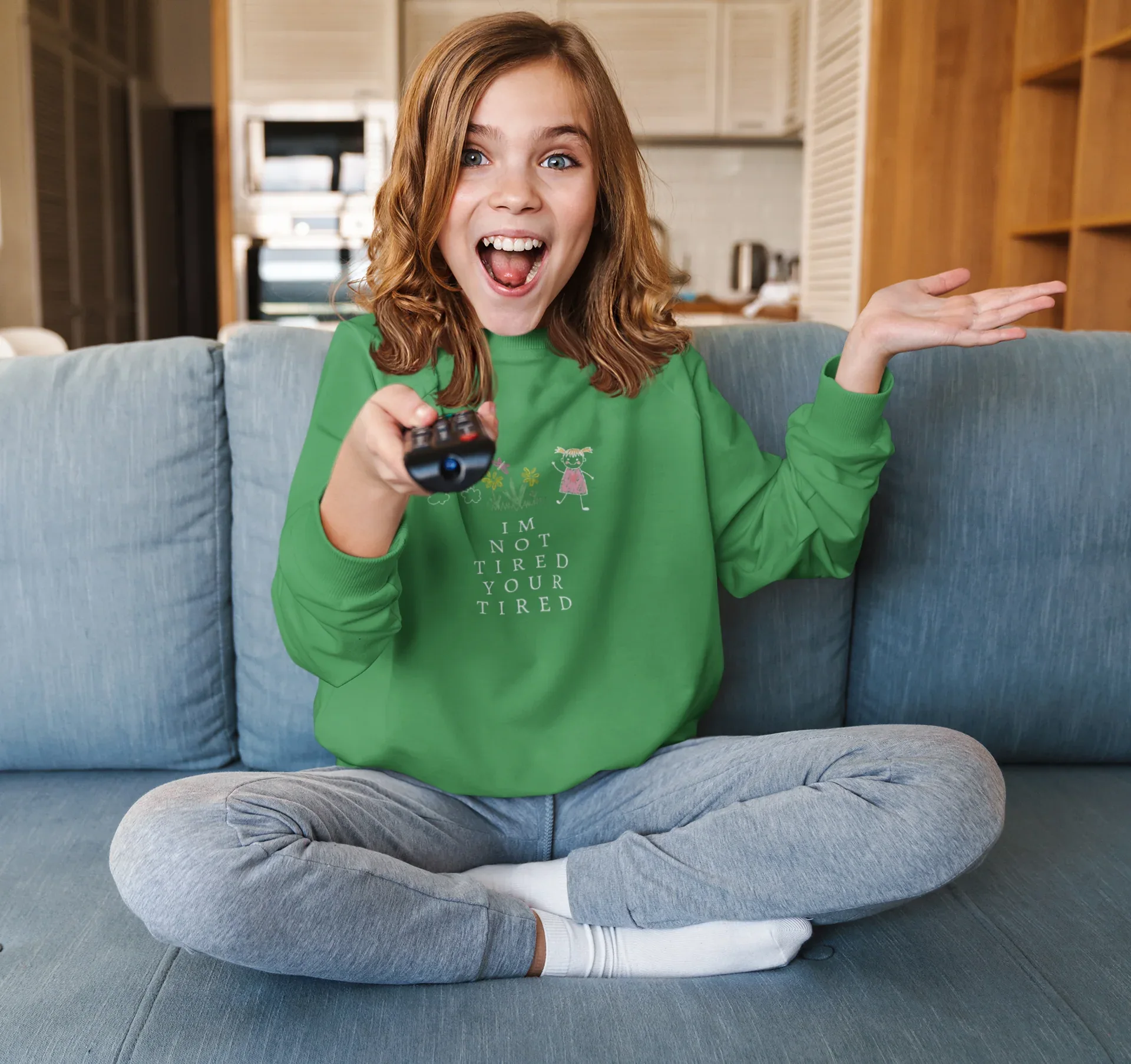 Kelly green kids sweatshirt with character graphic and 'I'm Not Tired, You're Tired' text