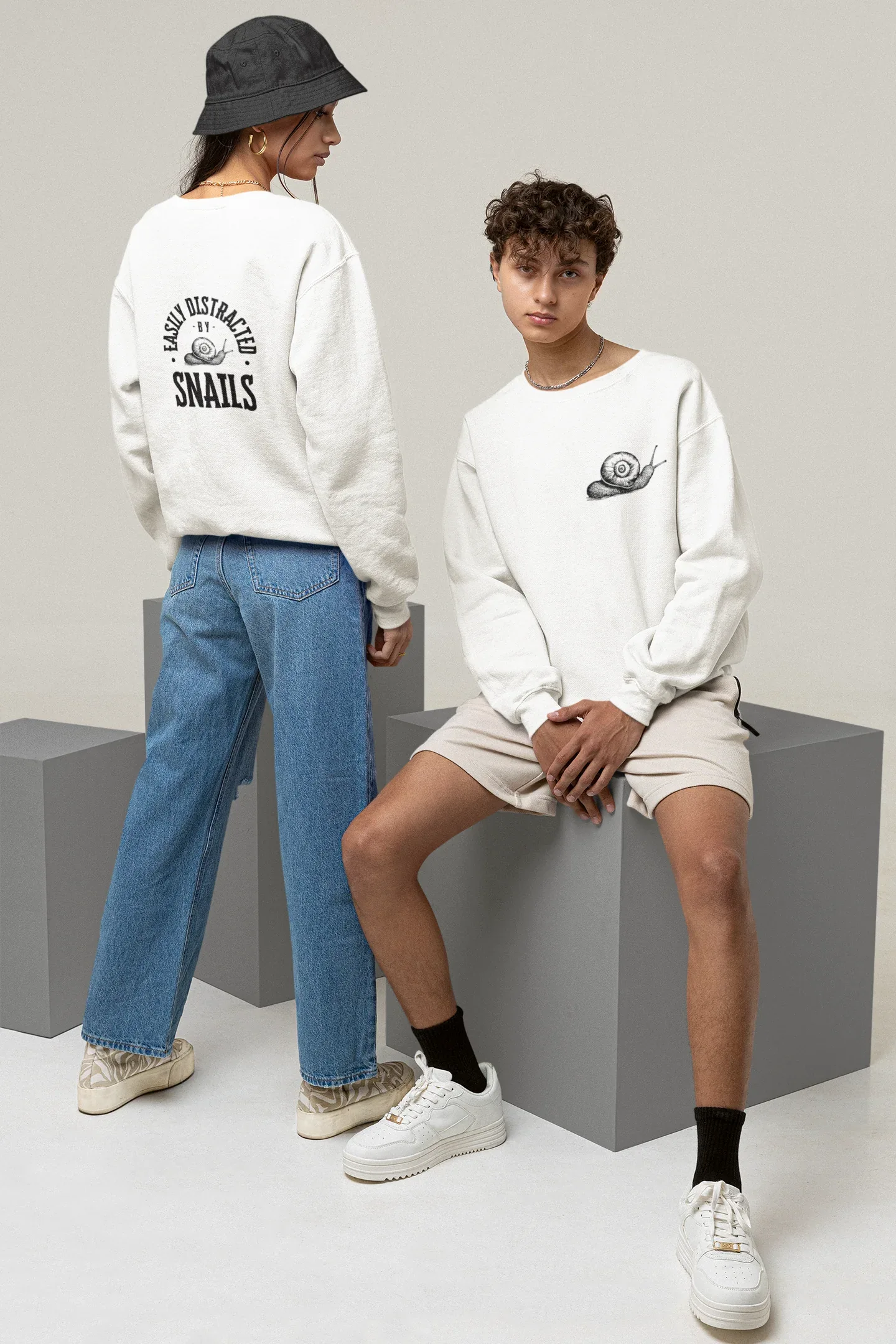 White sweatshirt with "Snails" back graphic and small chest emblem