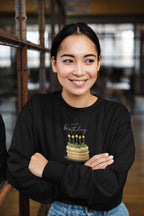 Black crewneck sweatshirt with “Happy birthday” cake and candle graphic