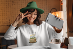 White birthday cake sweatshirt worn, front cake and candle graphic, crew neck.
