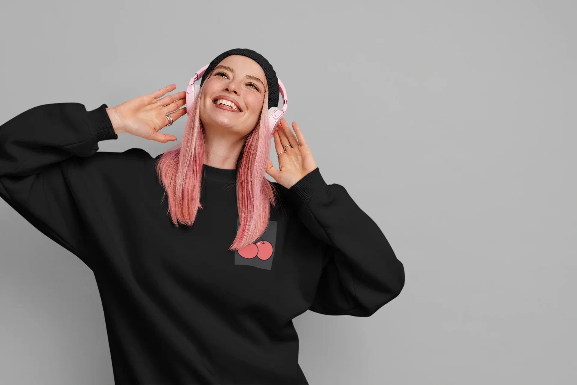 Embroidered sweatshirt in black with pink cherry logo at center chest