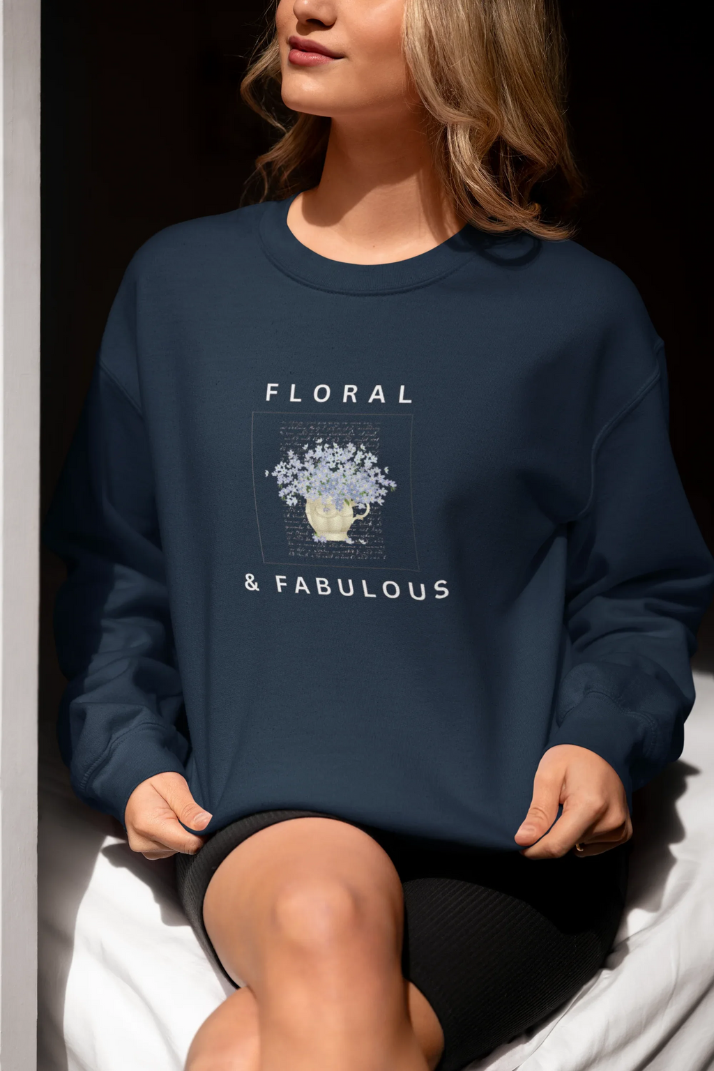 Navy sweatshirt with floral graphic and "FLORAL" and "& FABULOUS" text
