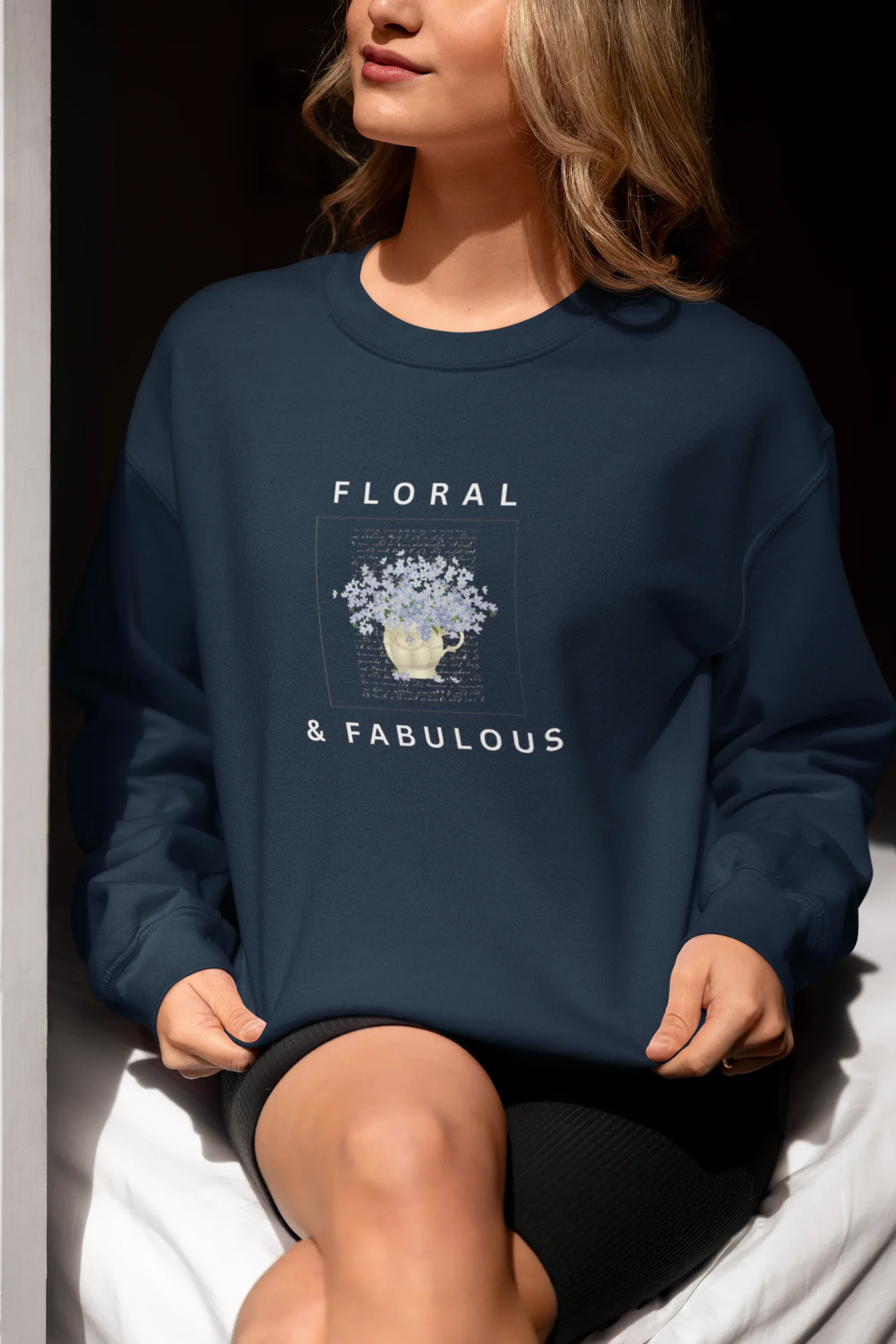 Navy sweatshirt with floral graphic and "FLORAL" and "& FABULOUS" text