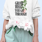 White sweatshirt with “Grow What You Go Through” text and leaf graphic