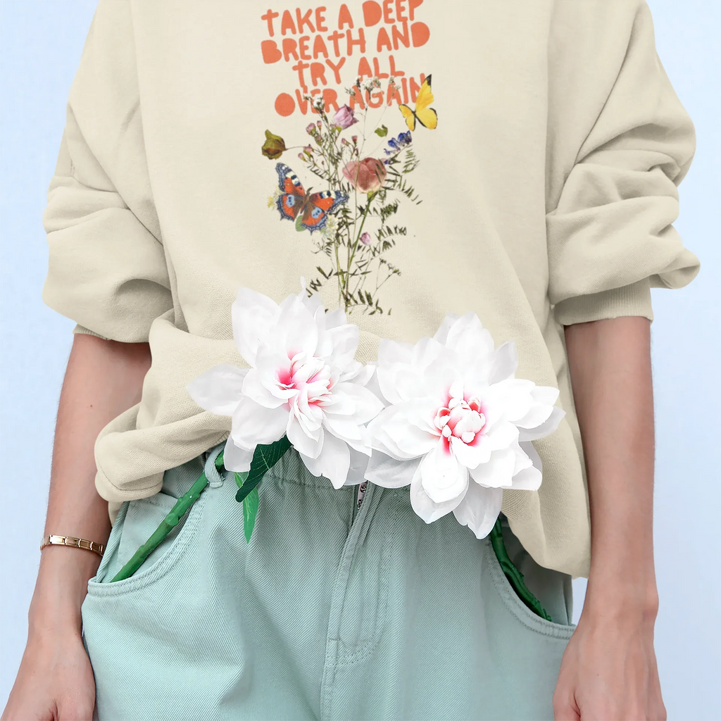 Light cream crewneck sweatshirt with floral quote graphic and ribbed hem