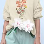 Light cream crewneck sweatshirt with floral quote graphic and ribbed hem