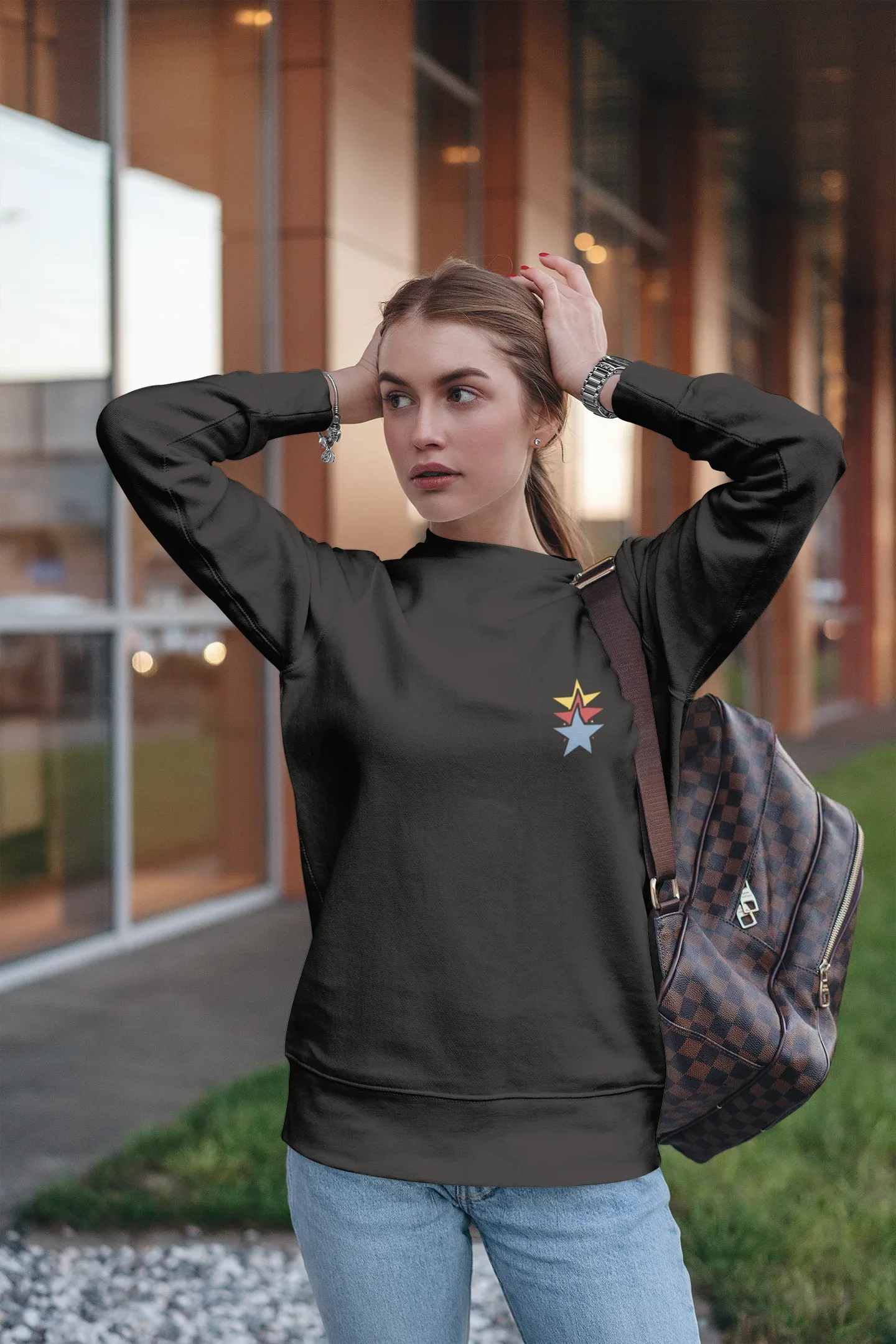 Unisex black sweatshirt with colorful star embroidery on the chest