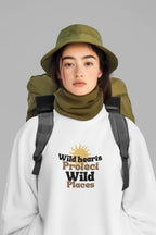 White crewneck sweatshirt worn with “Wild hearts Protect Wild Places” chest graphic