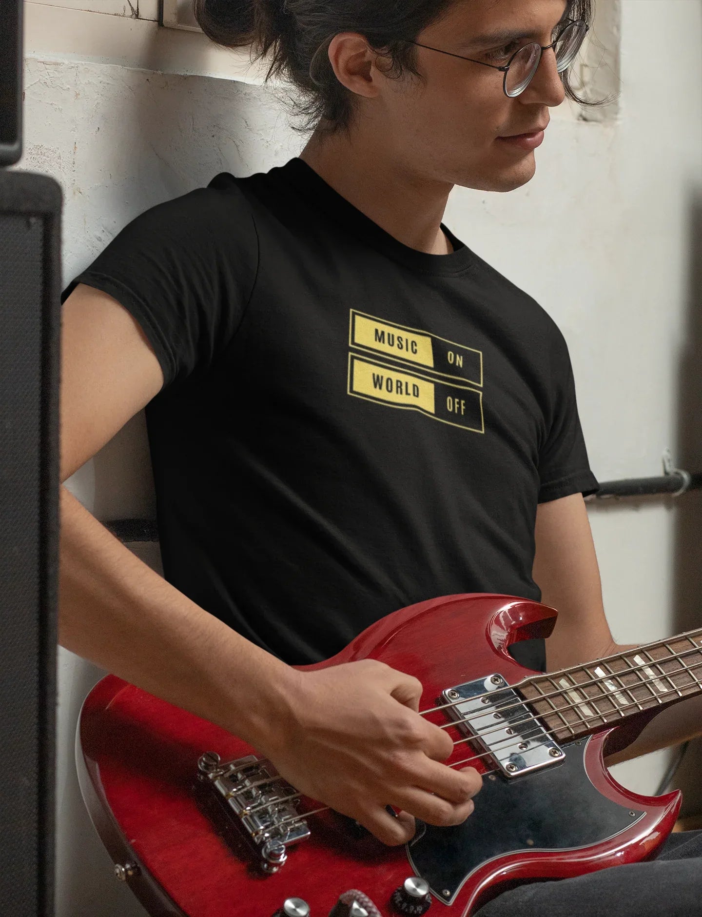 Black unisex T-shirt with “Music On / World Off” chest graphic