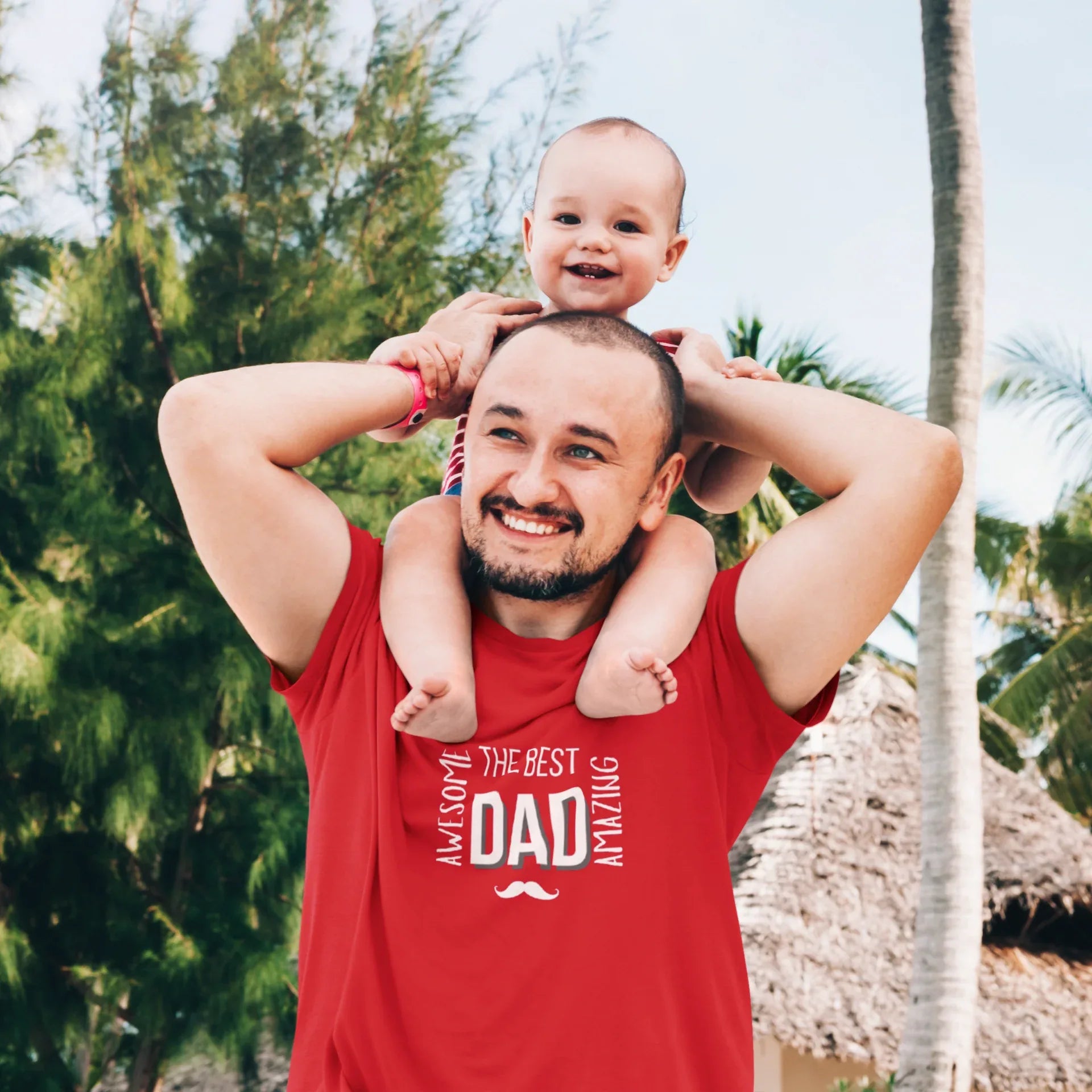 Red heavy cotton T-shirt with “The Best Dad” graphic and mustache emblem, worn by dad.