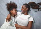 Pair of maternity heavy cotton tees in white, each with pink “Motherhood in Progress” print