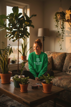 Green crewneck sweatshirt with “KEEP CALM…” text print on the chest