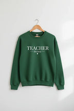 Green sweatshirt with TEACHER text and small Est.2023 graphic, crew neck