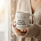 Personalised teacher thank-you mug held in hands, 'Mrs Smith' text and 'Class of 2025'.