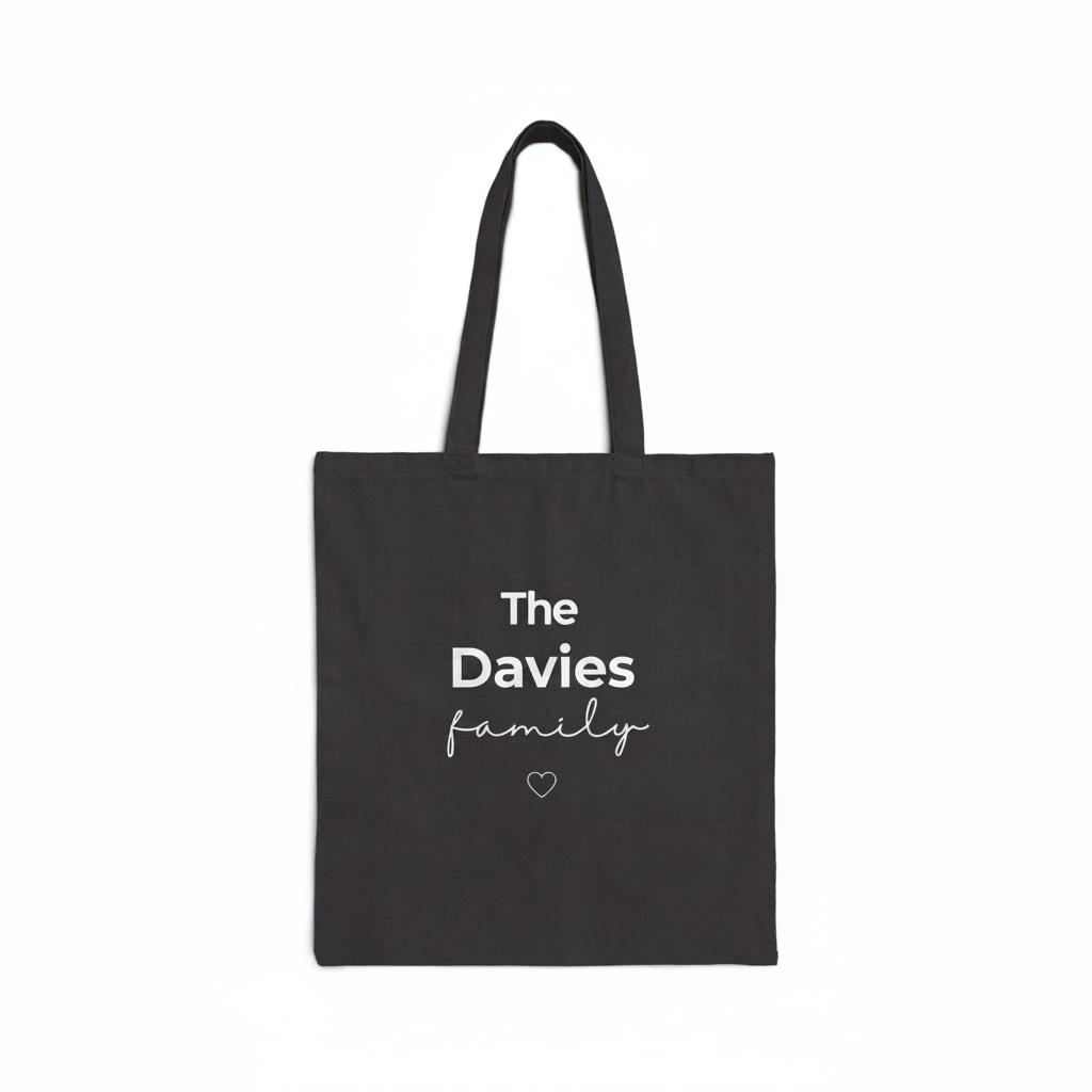 Black canvas tote bag with handles and “The Davies family” text and heart