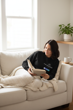 Deep black crewneck sweatshirt, long sleeves, printed chest graphic