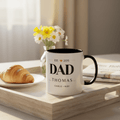 Two-tone coffee mug with black rim and handle, DAD and Thomas text on white body.