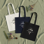 Cotton tote bags in white, navy blue, and black with mountain sketch heart print