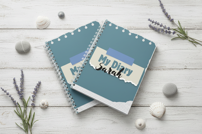 Three diaries stacked with shells and sea lavender