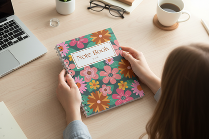 Top-down view of hands holding notebook at workspace