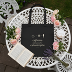 Black tote bag with coffee graphic and small icons, front view