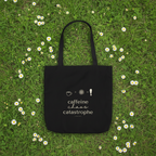 Black tote bag with “caffeine chaos catastrophe” print and cup + arrow icons.