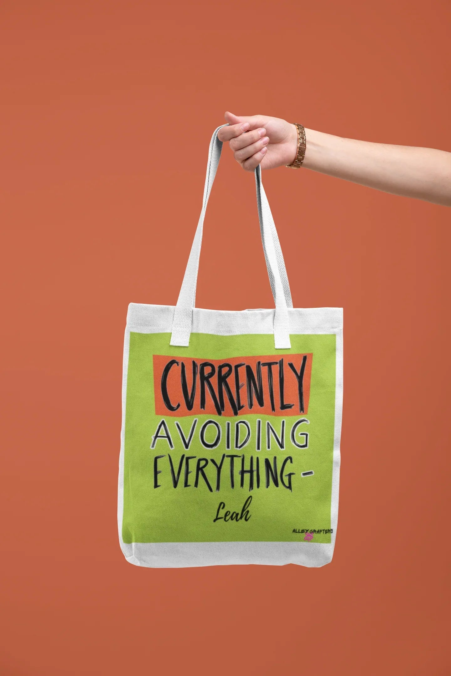 White canvas tote with lime green front panel and 'Currently Avoiding Everything-' text, Leah