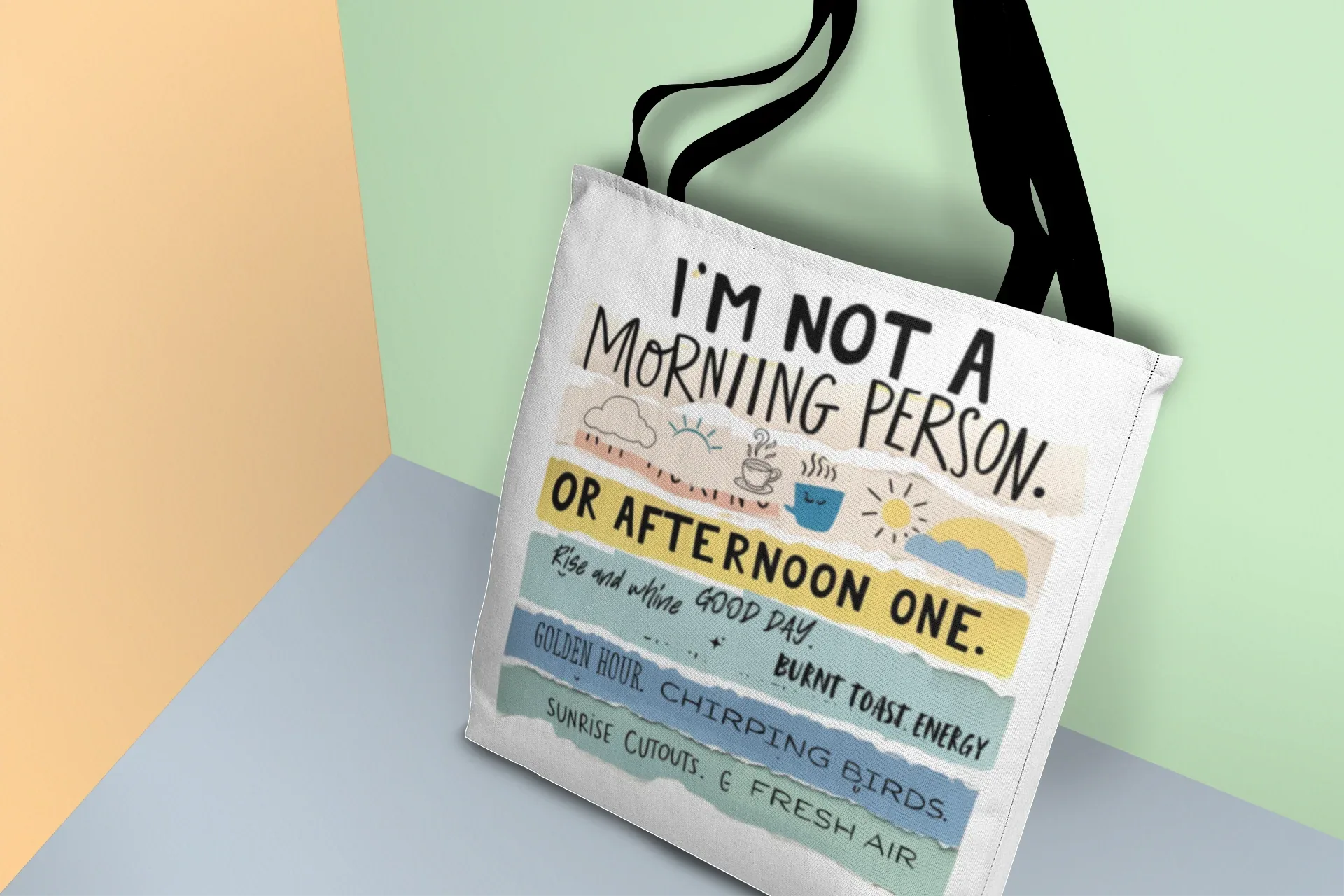 Beige tote bag with 'I'm not a morning person' and 'or afternoon one' text print