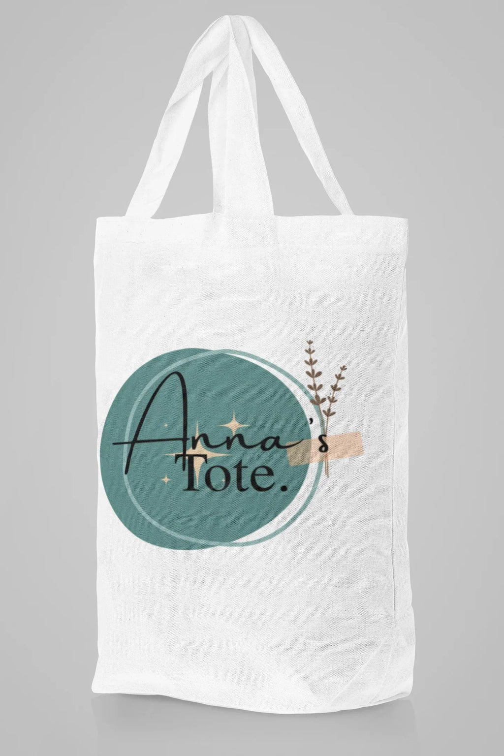 White canvas tote bag with rope handles and Hannah's Tote teal circle design