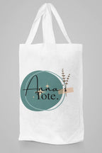 White canvas tote bag with rope handles and Hannah's Tote teal circle design