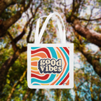 White tote bag with “good vibes” logo and colorful wavy stripes