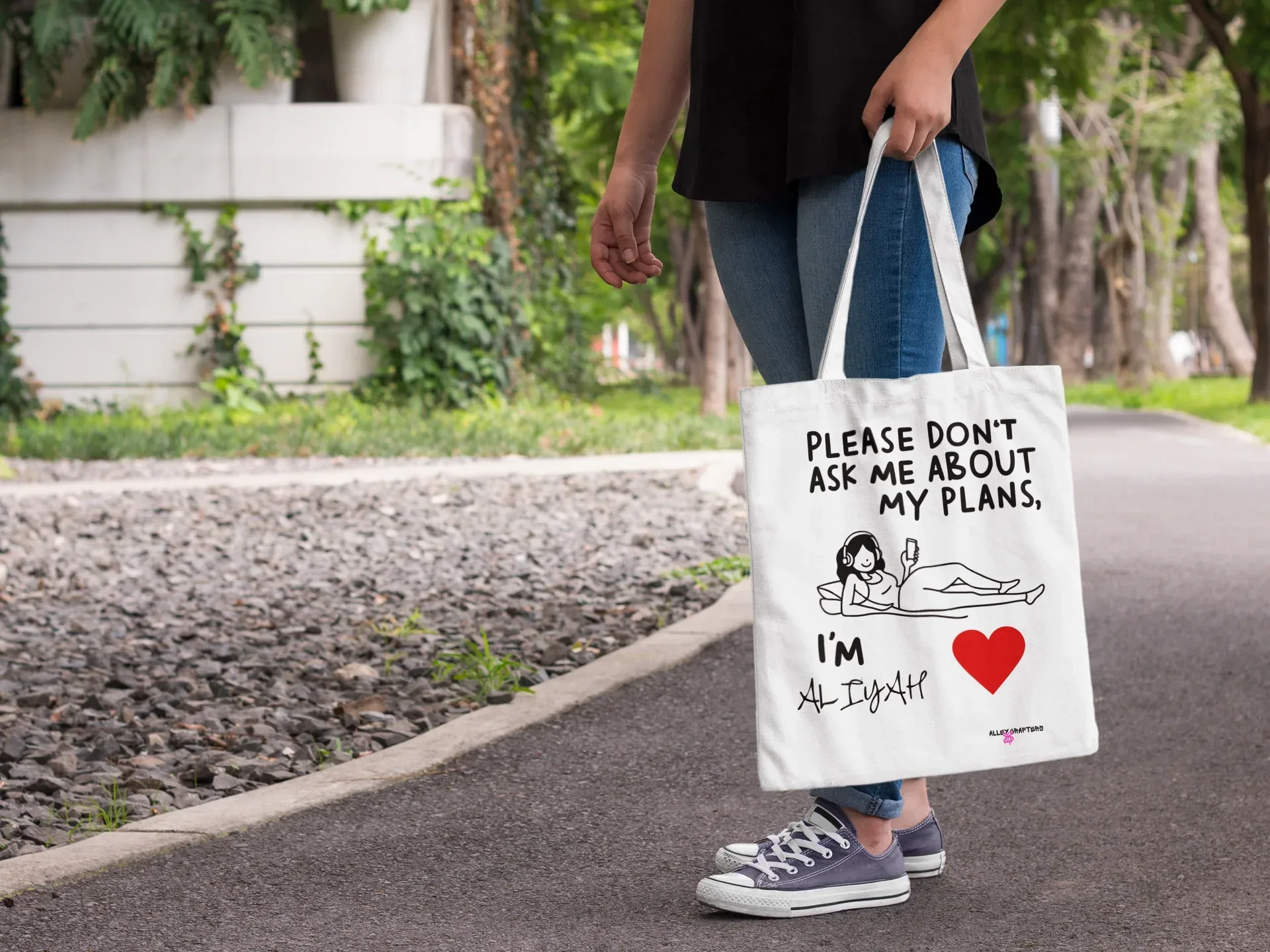 White canvas tote bag with black straps, “Please don’t ask me about my plans” quote and heart