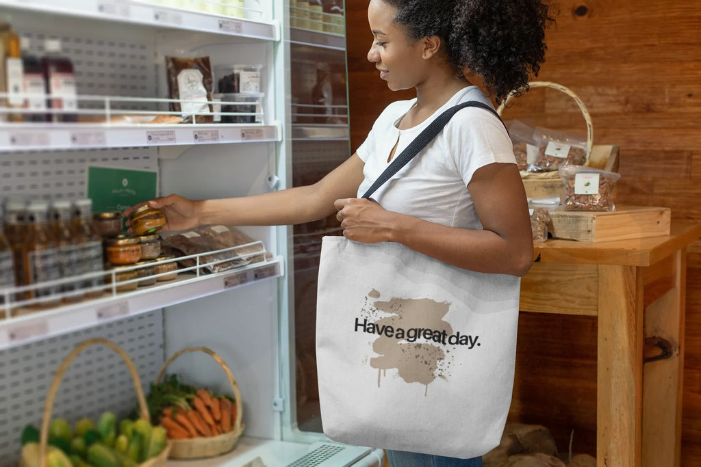 White canvas tote bag with “Have a great day.” text and brown splash design