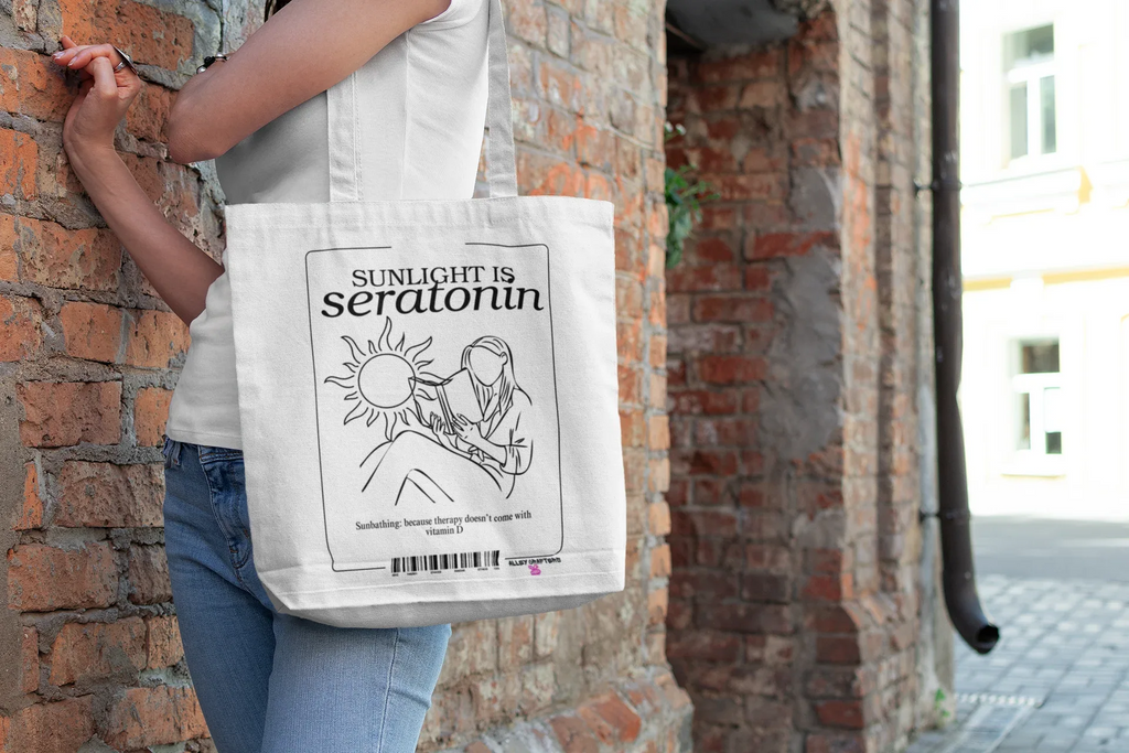 White canvas tote bag with black front print and over-the-shoulder handles