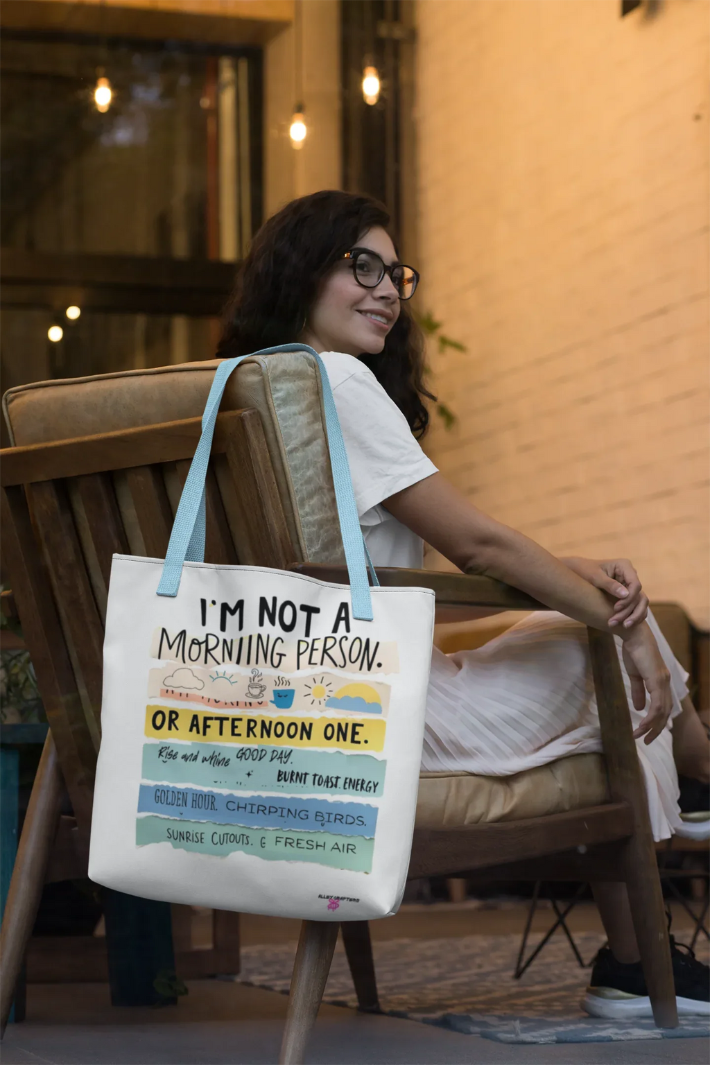 White canvas tote bag with light blue straps and printed morning person slogan