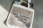 White tote bag with 'OVER THINKING EVERYTHING - Dianna' print and doodles