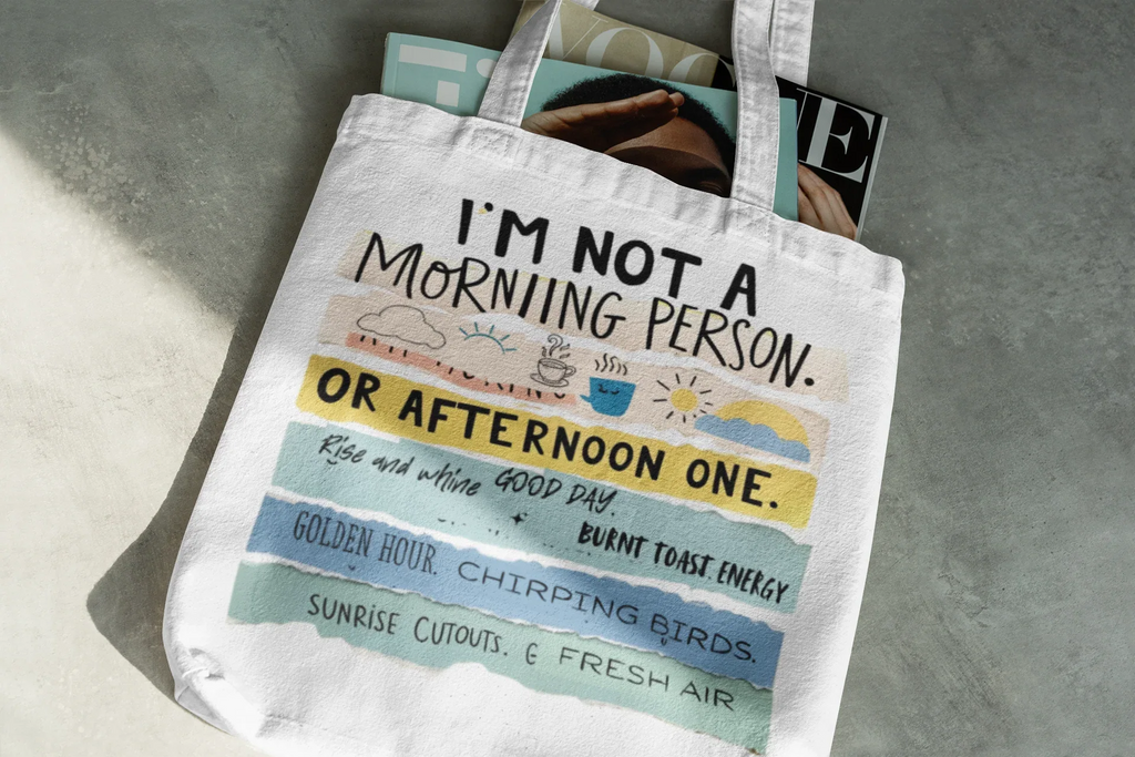 White tote bag with 'I'm not a morning person' slogan and colorful band print